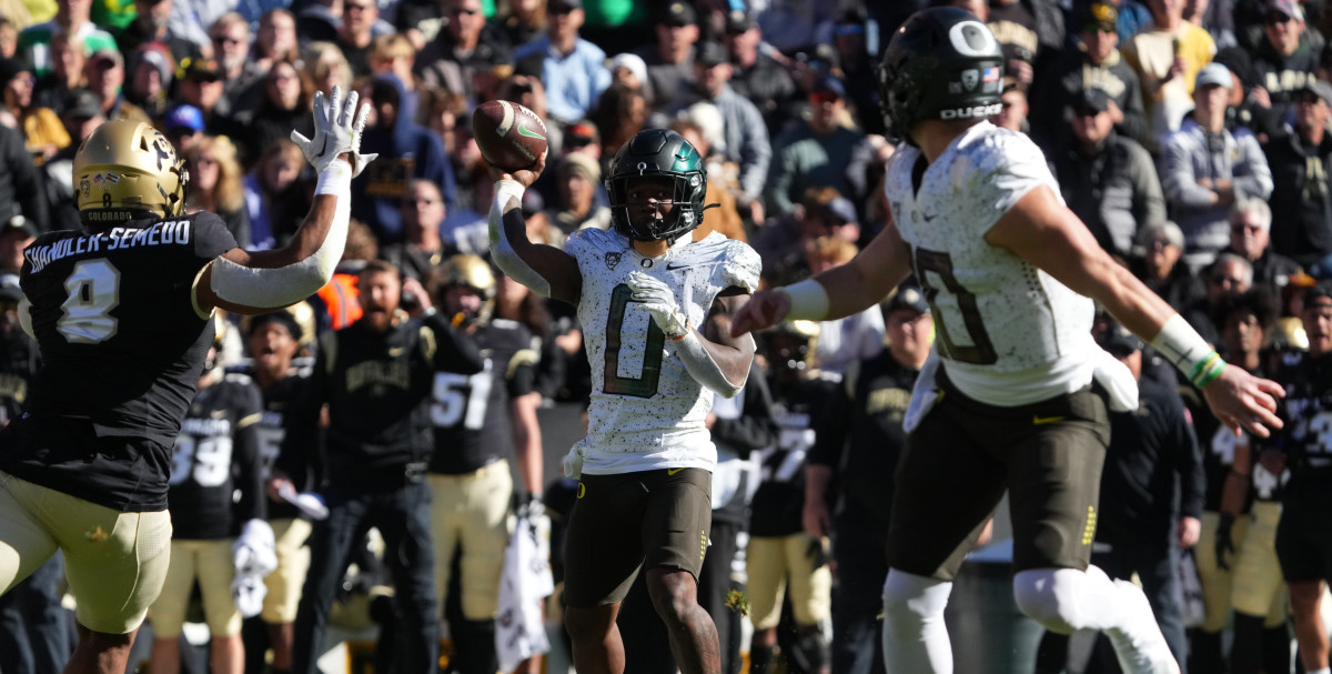 Running back Bucky Irving throws a touchdown to Bo Nix against Colorado.